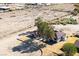 An aerial view features a home with a red roof, surrounded by trees and a spacious desert landscape at 1967 N Moapa Valley Blvd, Logandale, NV 89021