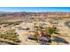 Aerial view features a home with a red tile roof in a desert community with mountain views at 1967 N Moapa Valley Blvd, Logandale, NV 89021