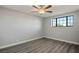 Cozy bedroom with wood-look floors, neutral walls, ceiling fan, and a large window at 1967 N Moapa Valley Blvd, Logandale, NV 89021