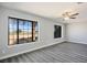 Inviting bedroom featuring a ceiling fan, large windows, and wood-look flooring at 1967 N Moapa Valley Blvd, Logandale, NV 89021