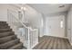 Inviting entryway features wood-look floors, a staircase with white wood banister, and a view of the chandelier at 1967 N Moapa Valley Blvd, Logandale, NV 89021