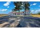 Spacious single-story house featuring large windows, a tile roof, and mature trees on a large lot at 1967 N Moapa Valley Blvd, Logandale, NV 89021