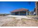 Spacious garage with ample parking and a durable concrete foundation on a sunny day at 1967 N Moapa Valley Blvd, Logandale, NV 89021