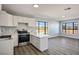 Modern kitchen boasts stainless steel appliances, a central island, and abundant natural light from large windows at 1967 N Moapa Valley Blvd, Logandale, NV 89021
