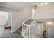 Open staircase features a white banister, views of the living room with a fireplace, and a nearby bathroom at 1967 N Moapa Valley Blvd, Logandale, NV 89021