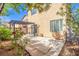 View of the backyard featuring a covered patio, mature landscaping, and house exterior at 1988 Villa De Sol St, Las Vegas, NV 89156