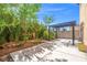 This backyard features a covered pergola, mature landscaping, and concrete patio at 1988 Villa De Sol St, Las Vegas, NV 89156