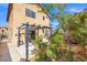 The backyard features a covered pergola, mature landscaping, and access to the house at 1988 Villa De Sol St, Las Vegas, NV 89156