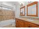 Bathroom featuring double sink vanity, granite counters, and tiled shower over tub at 1988 Villa De Sol St, Las Vegas, NV 89156