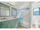 Updated bathroom featuring a double vanity, modern lighting, and glass shower doors at 1988 Villa De Sol St, Las Vegas, NV 89156