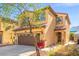 Home exterior showcasing desert landscaping, large front window, and a brown two-car garage at 1988 Villa De Sol St, Las Vegas, NV 89156