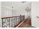 Hallway featuring decorative wrought iron railing and neutral carpeting at 1988 Villa De Sol St, Las Vegas, NV 89156