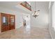 Living room featuring high ceilings, marble floors, iron staircase, and double-door entry at 1988 Villa De Sol St, Las Vegas, NV 89156