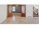 Marble flooring throughout the living room featuring decorative double doors and an open stair case at 1988 Villa De Sol St, Las Vegas, NV 89156