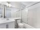 Bright bathroom features a white vanity, a large mirror, and a shower-tub combination at 2211 Arborwood Way, Las Vegas, NV 89142