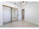 Bedroom with tile floors and mirrored closet sliding doors at 2211 Arborwood Way, Las Vegas, NV 89142