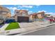 Charming two-story home with a two-car garage, low maintenance front yard, and desert landscaping at 2211 Arborwood Way, Las Vegas, NV 89142