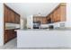 Traditional kitchen featuring wood cabinets, granite countertops, and tile flooring at 2211 Arborwood Way, Las Vegas, NV 89142