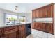 Kitchen with plenty of cabinet space and countertops with a double sink and backyard view at 2211 Arborwood Way, Las Vegas, NV 89142