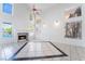 Bright living room with fireplace, tile floors, high ceilings, and abundant natural light at 2211 Arborwood Way, Las Vegas, NV 89142