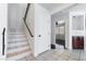 Staircase in the foyer with tile floors and a view into the living room at 2211 Arborwood Way, Las Vegas, NV 89142