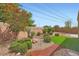 Well-manicured backyard featuring lush landscaping and rock garden at 2324 Willow Wren Dr, North Las Vegas, NV 89084