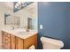 Modern bathroom features dual sinks, spacious counters, and blue accent wall at 2324 Willow Wren Dr, North Las Vegas, NV 89084