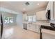Well-lit kitchen with white cabinets, modern appliances, and tile flooring for easy maintenance at 2324 Willow Wren Dr, North Las Vegas, NV 89084