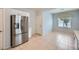 Bright kitchen features stainless steel refrigerator, tile floors, and white cabinets at 2324 Willow Wren Dr, North Las Vegas, NV 89084