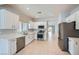 Kitchen featuring stainless appliances, tile floor, and white cabinetry at 2324 Willow Wren Dr, North Las Vegas, NV 89084
