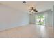 Bright living room with tile floors and sliding glass doors, offering a view of the backyard at 2324 Willow Wren Dr, North Las Vegas, NV 89084