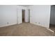 The bedroom features neutral carpet, with multiple doorways for easy access at 2431 Old Forge Ln # 101, Las Vegas, NV 89121