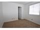 This bedroom features neutral carpet and a window for natural light at 2431 Old Forge Ln # 101, Las Vegas, NV 89121