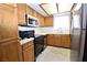 Efficient kitchen featuring oak cabinets, stainless steel appliances, and tile countertops at 2431 Old Forge Ln # 101, Las Vegas, NV 89121