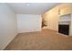 Bright living room featuring carpet, a fireplace, and staircase to second level at 2431 Old Forge Ln # 101, Las Vegas, NV 89121