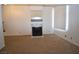 Large living room featuring carpet, a fireplace, and lots of natural light at 2431 Old Forge Ln # 101, Las Vegas, NV 89121