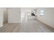 Bright living area with hardwood floors leading to the kitchen at 2618 Lily Point St, Las Vegas, NV 89156