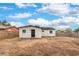 Spacious backyard featuring a detached building, secured by a block wall fence at 2621 Bello Dr, North Las Vegas, NV 89030