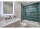 Modern bathroom featuring a built-in tub, stylish tile, sleek fixtures, and an illuminated mirror above the vanity at 2621 Bello Dr, North Las Vegas, NV 89030