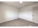 Carpeted bedroom featuring modern baseboards, white walls, and a light fixture at 2621 Bello Dr, North Las Vegas, NV 89030