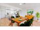 Staged dining room with modern table and chairs, adjacent to the open concept kitchen and living area at 2621 Bello Dr, North Las Vegas, NV 89030