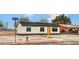 Well-maintained single-story home with a bright yellow front door, gravel landscaping, and mountain views at 2621 Bello Dr, North Las Vegas, NV 89030