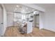 Eat in kitchen boasts a center island with barstool seating, quartz countertops, and stainless appliances at 2621 Bello Dr, North Las Vegas, NV 89030