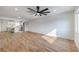 Spacious open-concept living area with wood floors, bright lighting, and a modern kitchen in the background at 2621 Bello Dr, North Las Vegas, NV 89030