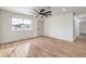 Inviting living room boasts wood-look floors, a modern ceiling fan, and plenty of natural light from the window at 2621 Bello Dr, North Las Vegas, NV 89030