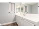 Bathroom features white cabinets, white tile countertop, and double vanity mirror at 2842 Mahogany Grove Ave, Henderson, NV 89074