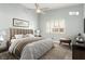 A well-staged bedroom featuring a large bed, ceiling fan, and neutral colors for a serene atmosphere at 2842 Mahogany Grove Ave, Henderson, NV 89074
