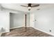 Bright bedroom featuring a ceiling fan, built-in shelves, and modern flooring at 2842 Mahogany Grove Ave, Henderson, NV 89074