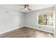 Well-lit bedroom with a ceiling fan, hardwood floors, and a large window at 2842 Mahogany Grove Ave, Henderson, NV 89074