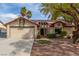 Charming single-story home with a well-manicured yard, desert landscaping, and a two-car garage at 2842 Mahogany Grove Ave, Henderson, NV 89074